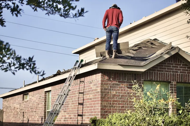 Professional roofer working on a residential roof in Knoll Ridge